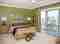 Florida style guest bedroom with beautiful green walls painted by Pelican Painting Company